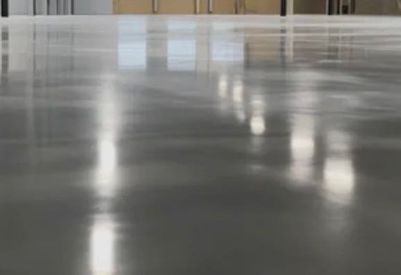 High-gloss polished concrete floor with exposed aggregate for a showroom